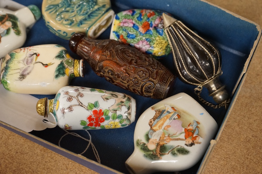 A group of Chinese snuff bottles to include porcelain, bone, enamelled, glass and amber examples, tallest 8cm. Condition - varies